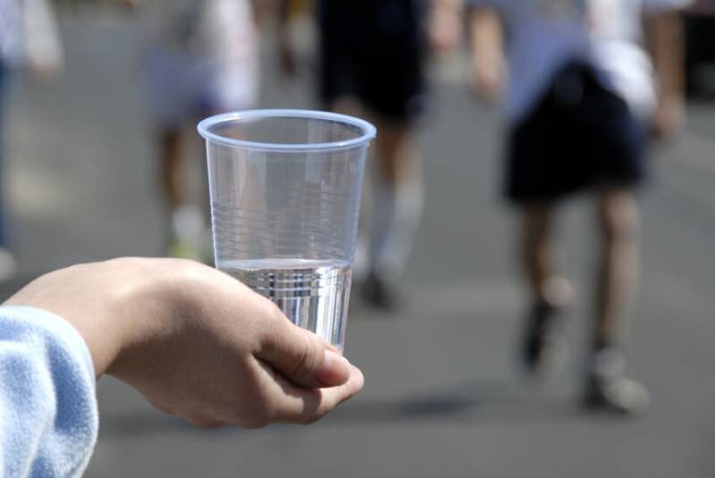 Hand holding a cup of water during a San Francisco race
